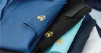 A stack of shirts with embroidery on them